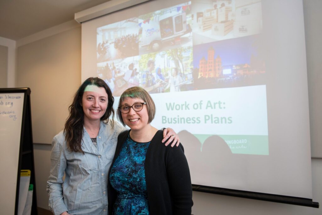 Work of Art workshop instructor Jes Reyes (right) poses with a workshop attendee after a business planning workshop. Photo: Bruce Silcox.